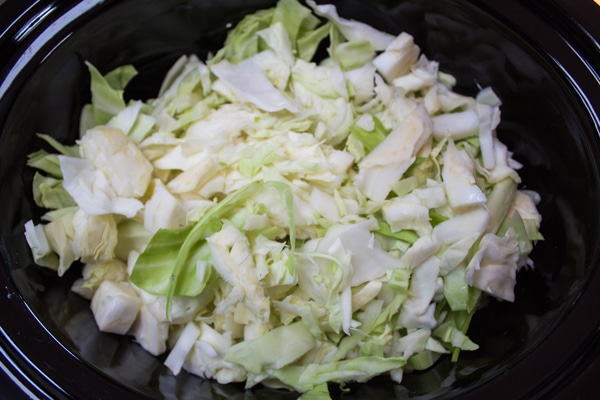 chopped cabbage set into crockpot.