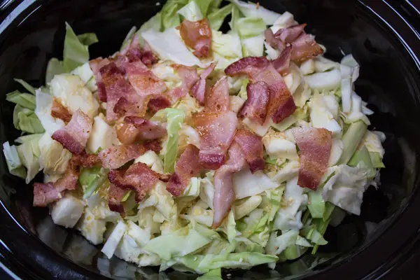 chopped cooked bacon added to the crockpot cabbage.