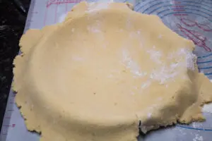 rolled pastry dough transferred into the tart pan.
