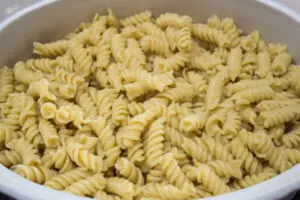 the first layer in the italian sausage bake is rotini or penne pasta.