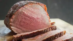 wide image of the perfect Smoked Beef Roast sliced and ready to serve.