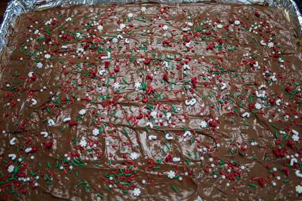 top the christmas crack saltine toffee with nuts or christmas sprinkles.