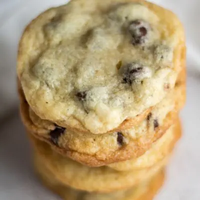 pin with stacked chocolate chip cookies without brown sugar and text overlay.