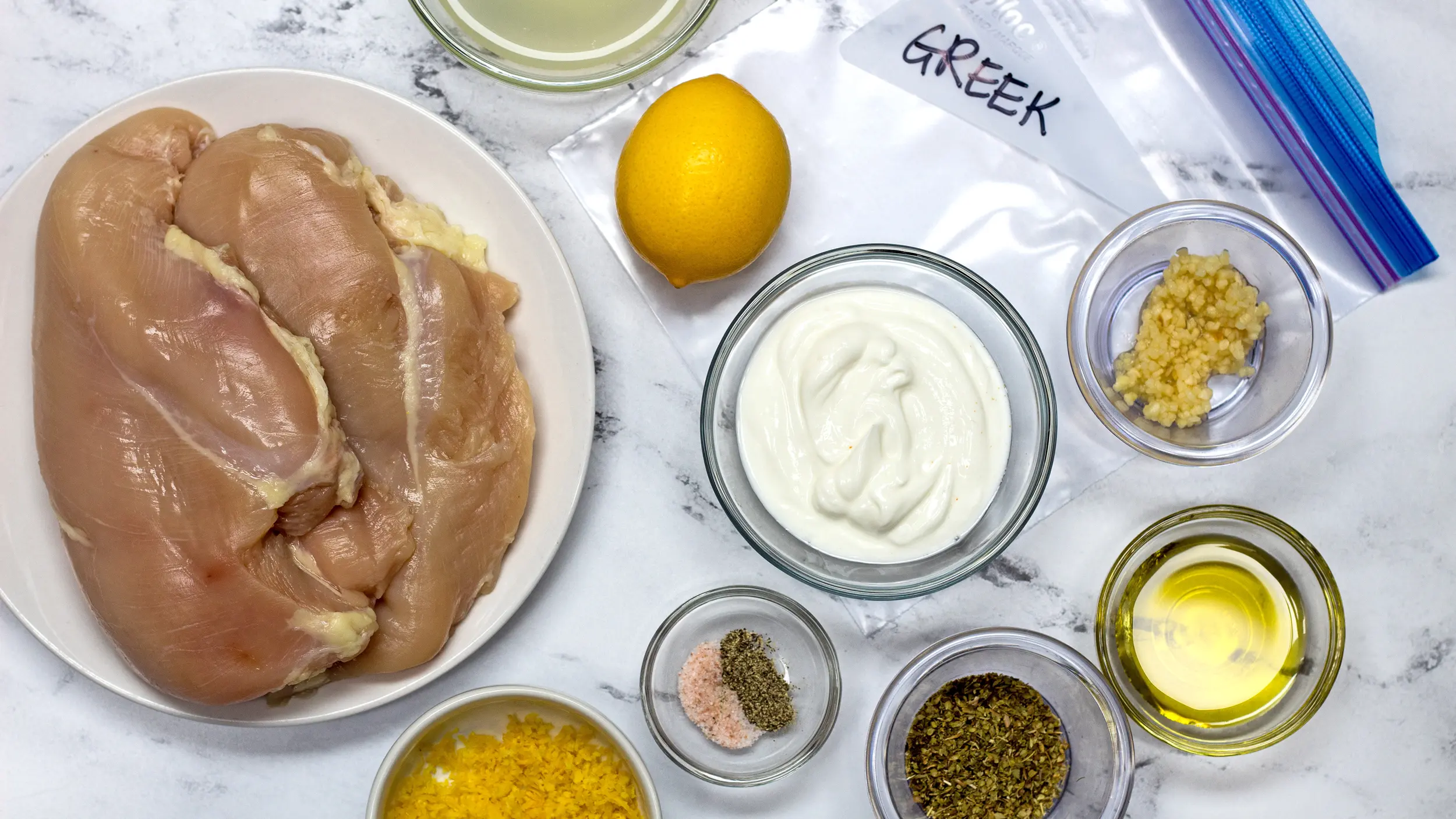 wide Greek Chicken Marinade ingredients with chicken.
