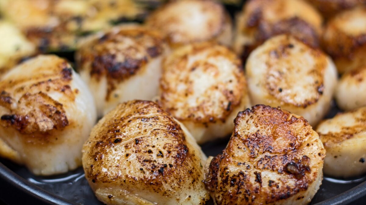wide image of easy hibachi scallops served with zucchini.