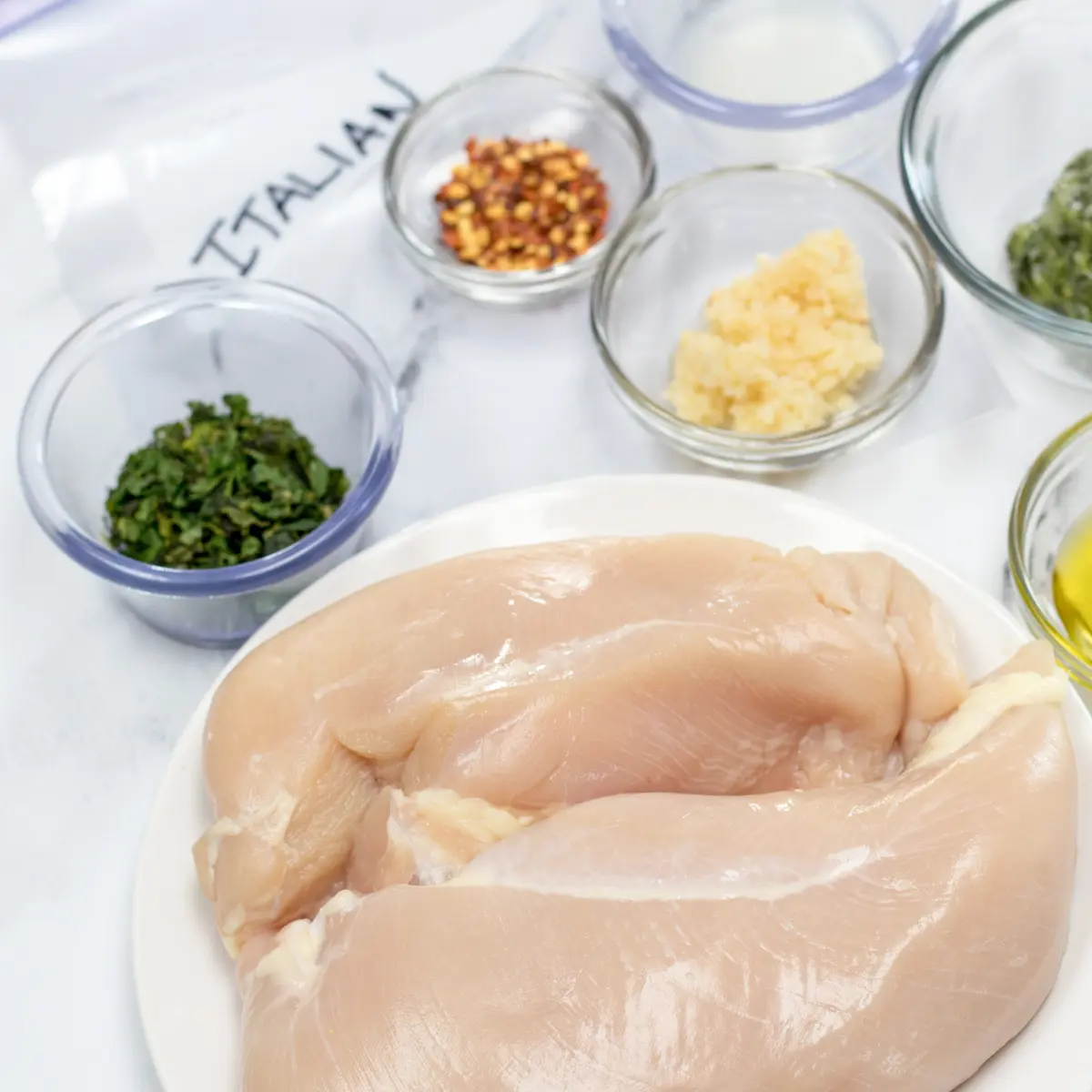 Square image of ingredients for an Italian chicken marinade.