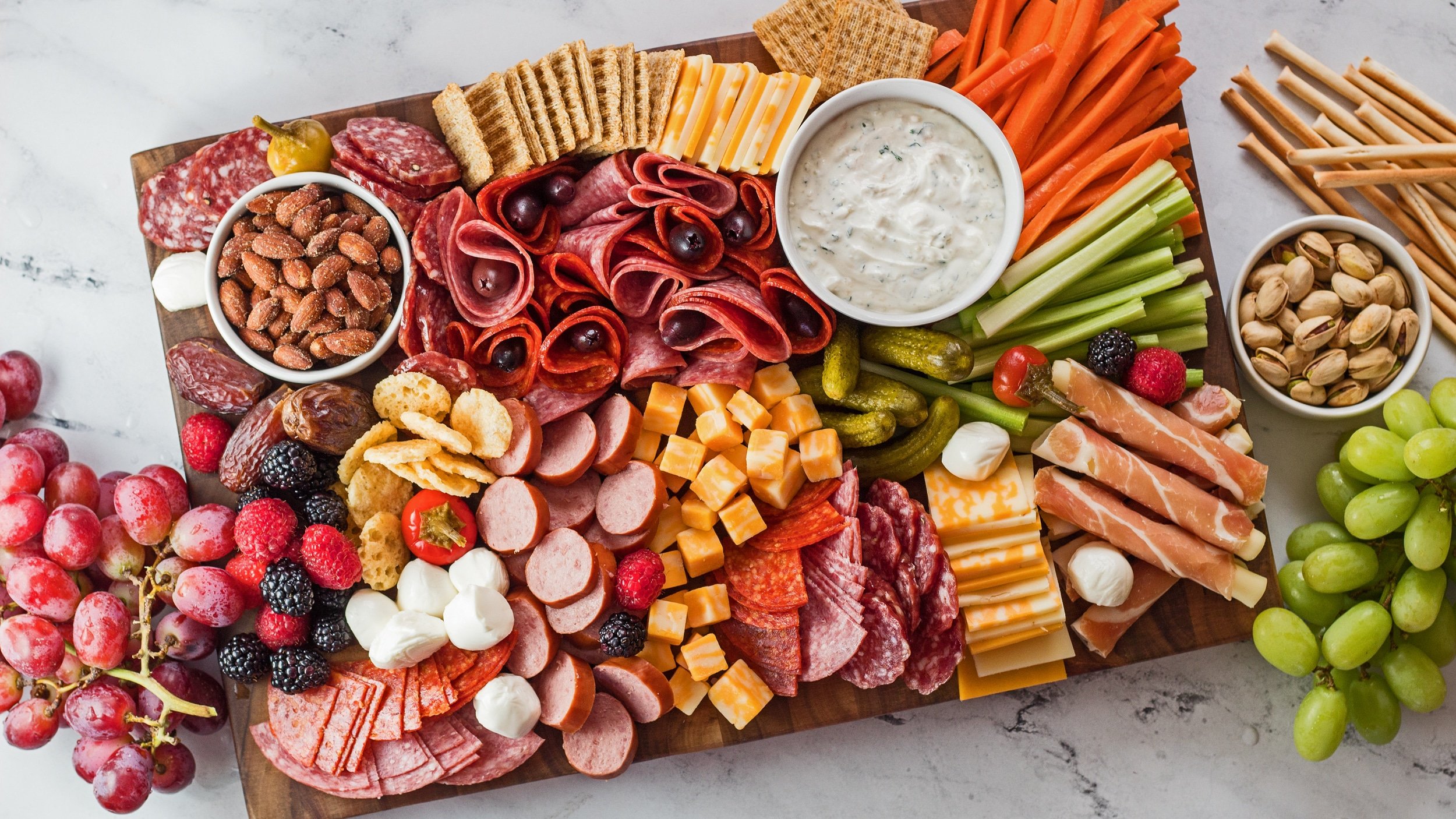 Wide overhead image of charcuterie board.