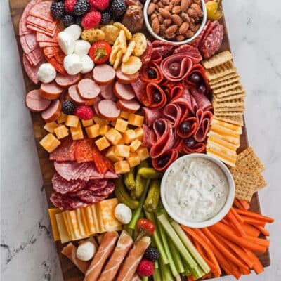 Charcuterie board pin with text overlay.
