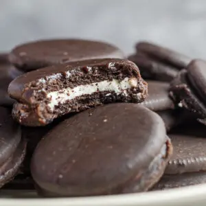 Large square luscious fudge covered oreos stacked to enjoy.