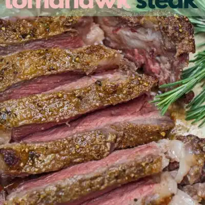 Tall image of reverse sear tomahawk steak with text overlay.