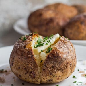 Large square image of tasty smoked baked potato with butter.