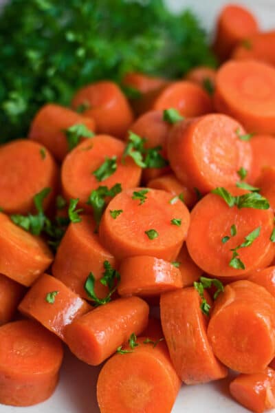 Tall overhead closeup of the microwave carrots on white plate.