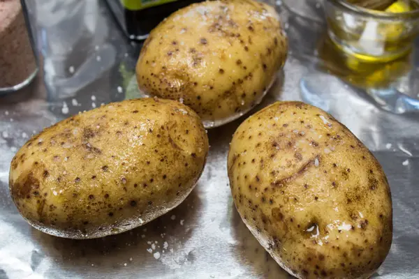 Olive oil coated potatoes with salt.