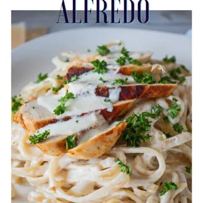 Pin with closeup of grilled chicken fettuccine alfredo and text header.