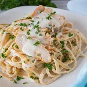 Grilled chicken fettuccine alfredo with sliced chicken served over pasta.