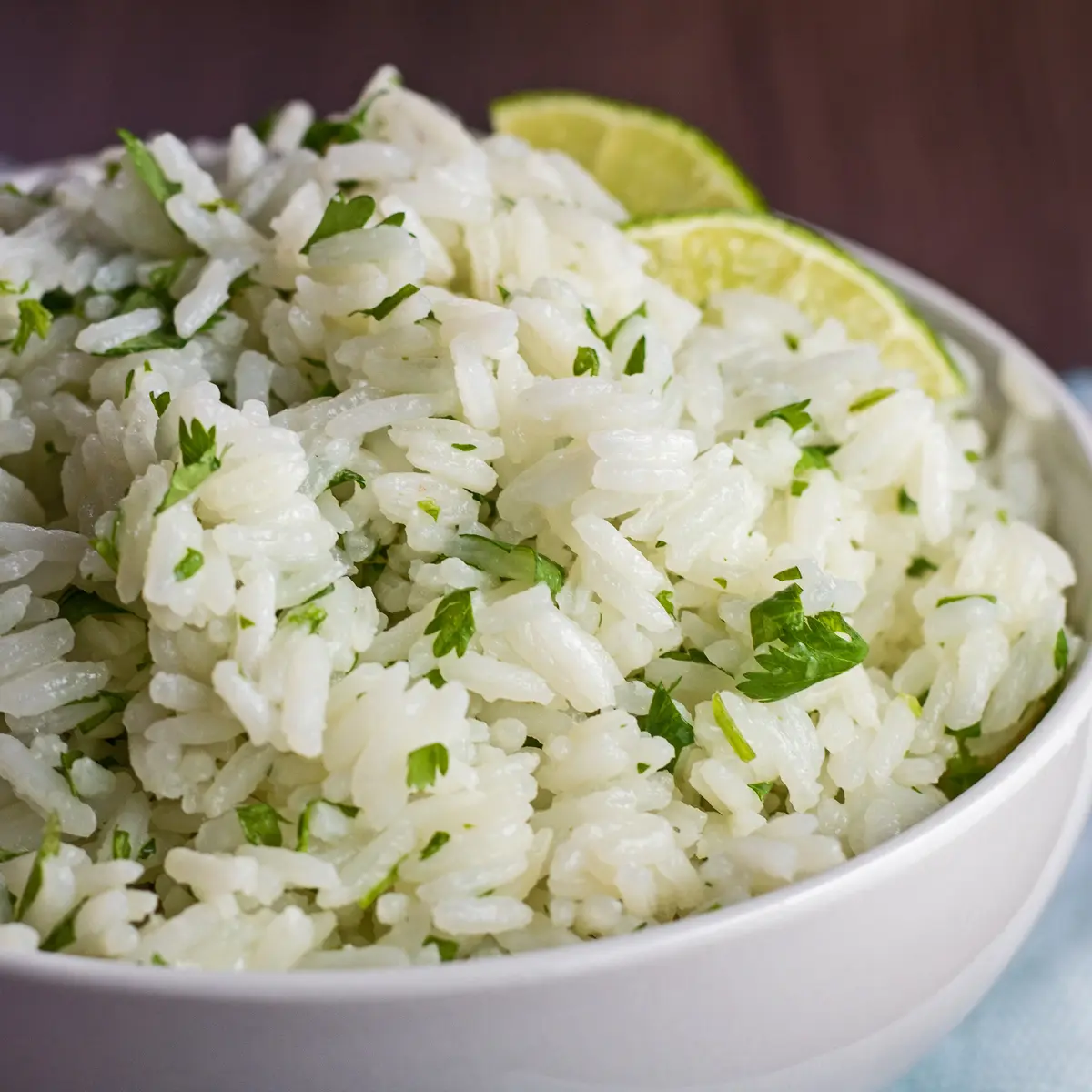 Closeup square of the instant pot cilantro lime rice dished in white bowl.