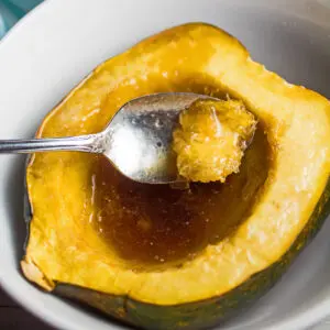 Perfectly cooked microwave acorn squash filled with butter and brown sugar.