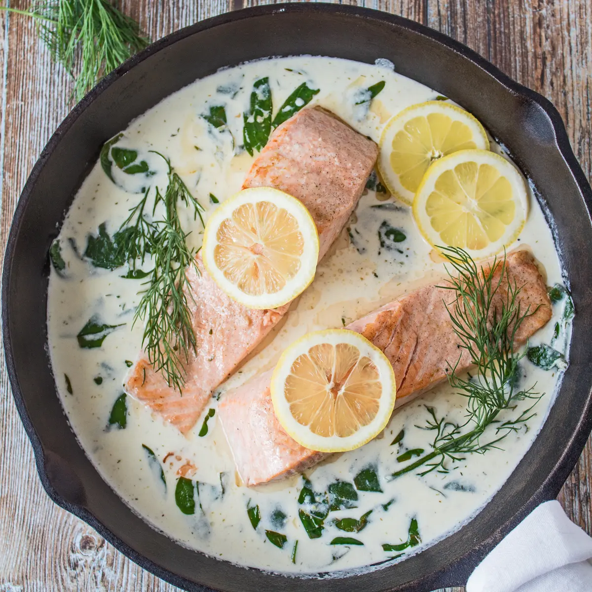 Salmon in White Wine Sauce with dill and spinach.