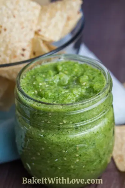 Authentic salsa verde or tomatilla salsa is served with crispy tortilla chips.