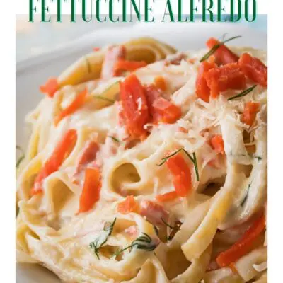 Pin with plated smoked salmon fettuccine alfredo and text header.