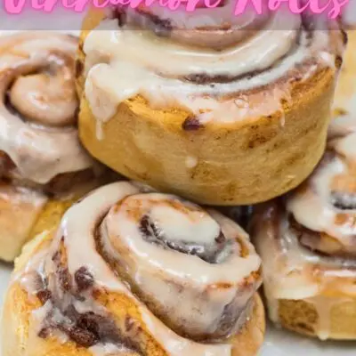Air fryer cinnamon rolls in white plate with text overlay.