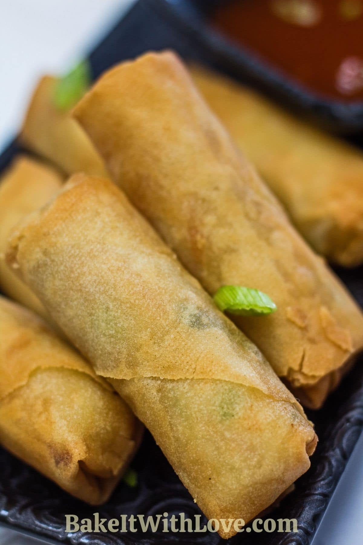 Tall image closeup on the perfectly crisped air fryer frozen spring rolls.