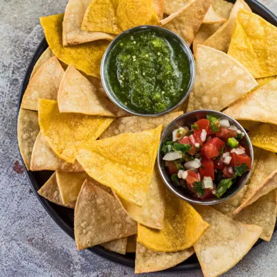 Air fryer tortilla chips served with pico de gallo and salsa verde.