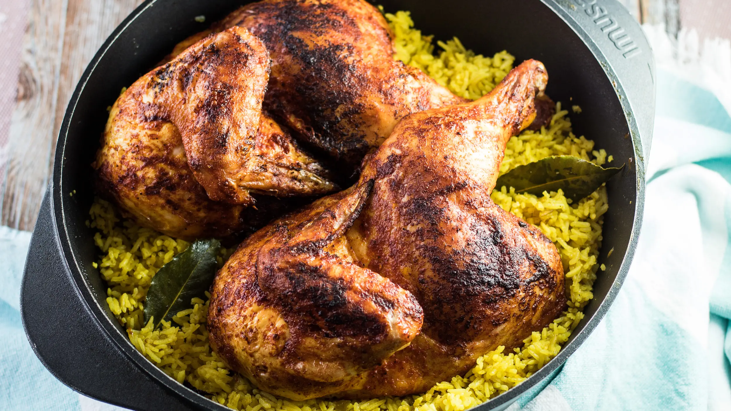 Chicken mandi over smoky rice in dutch oven.