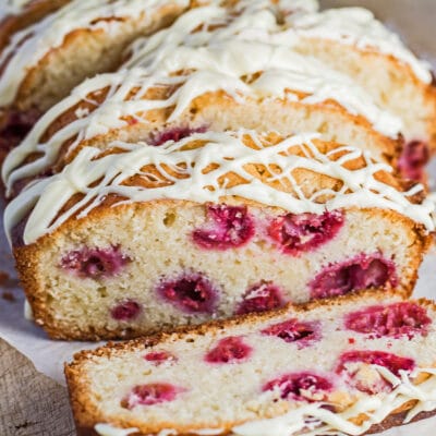 Sliced White Chocolate and Raspberry Loaf Cake with white chocolate drizzle.