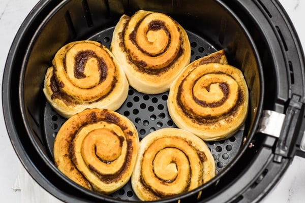 Checking the cinnamon rolls after 8 minutes in air fryer.
