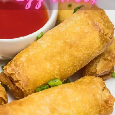 Air Fryer frozen Egg Rolls cooked on white plate with text overlay.