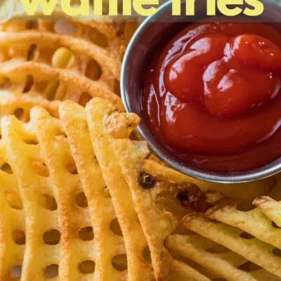 Air fryer waffle fries cooked and served with ketchup.