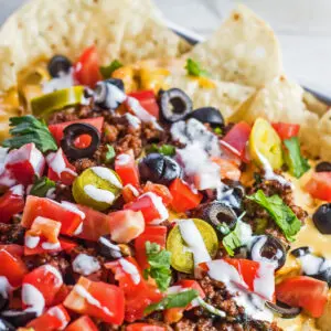 Loaded nachos supreme with nacho toppings.