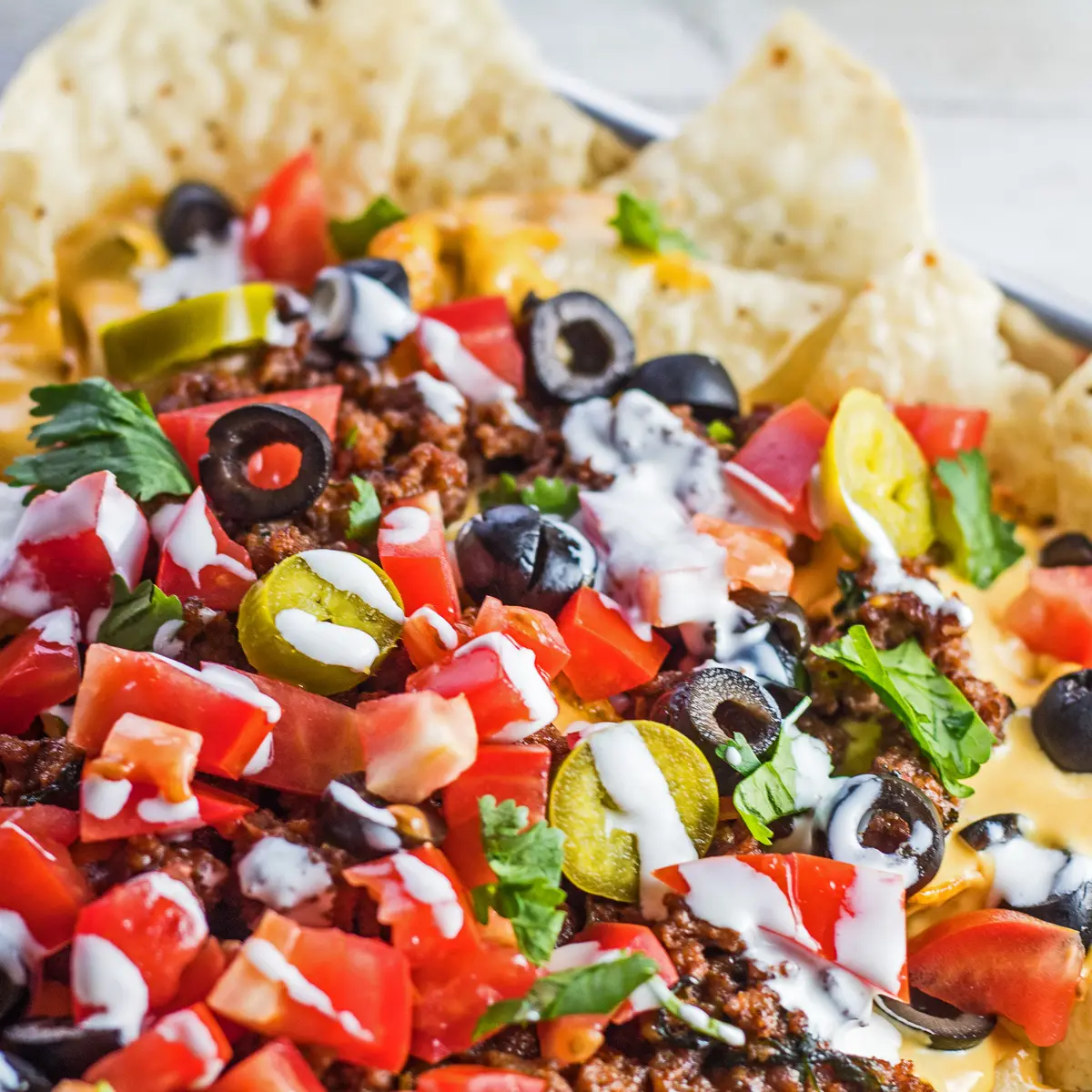 Loaded nachos supreme with nacho toppings.
