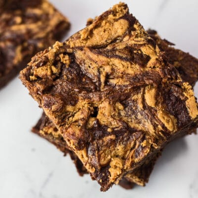 Marbled peanut butter banana brownie squares stacked.