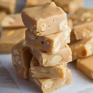 Creamy microwave peanut butter fudge sliced and stacked.
