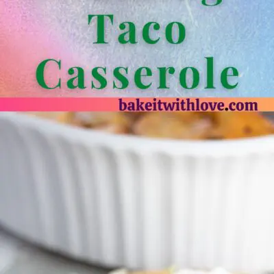 Walking taco casserole plated and served with lettuce, sour cream, pico de gallo, and avocado.