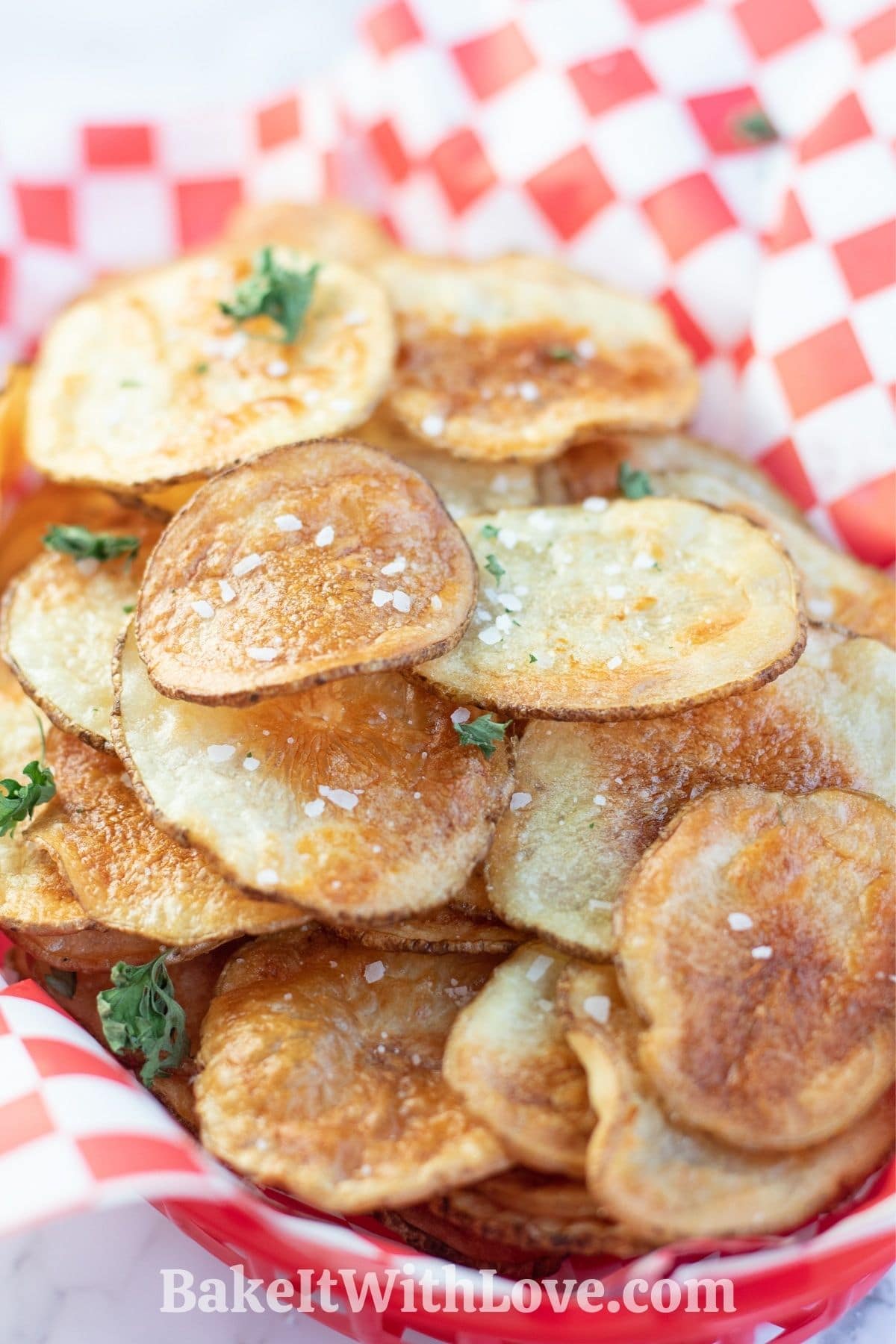 Piled air fryer potato chips in a picnic basket.