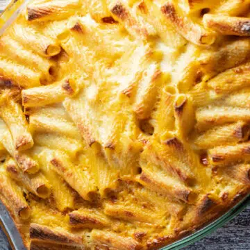 Perfectly golden baked bechamel pasta bake or macarona bechamel served in casserole dish.