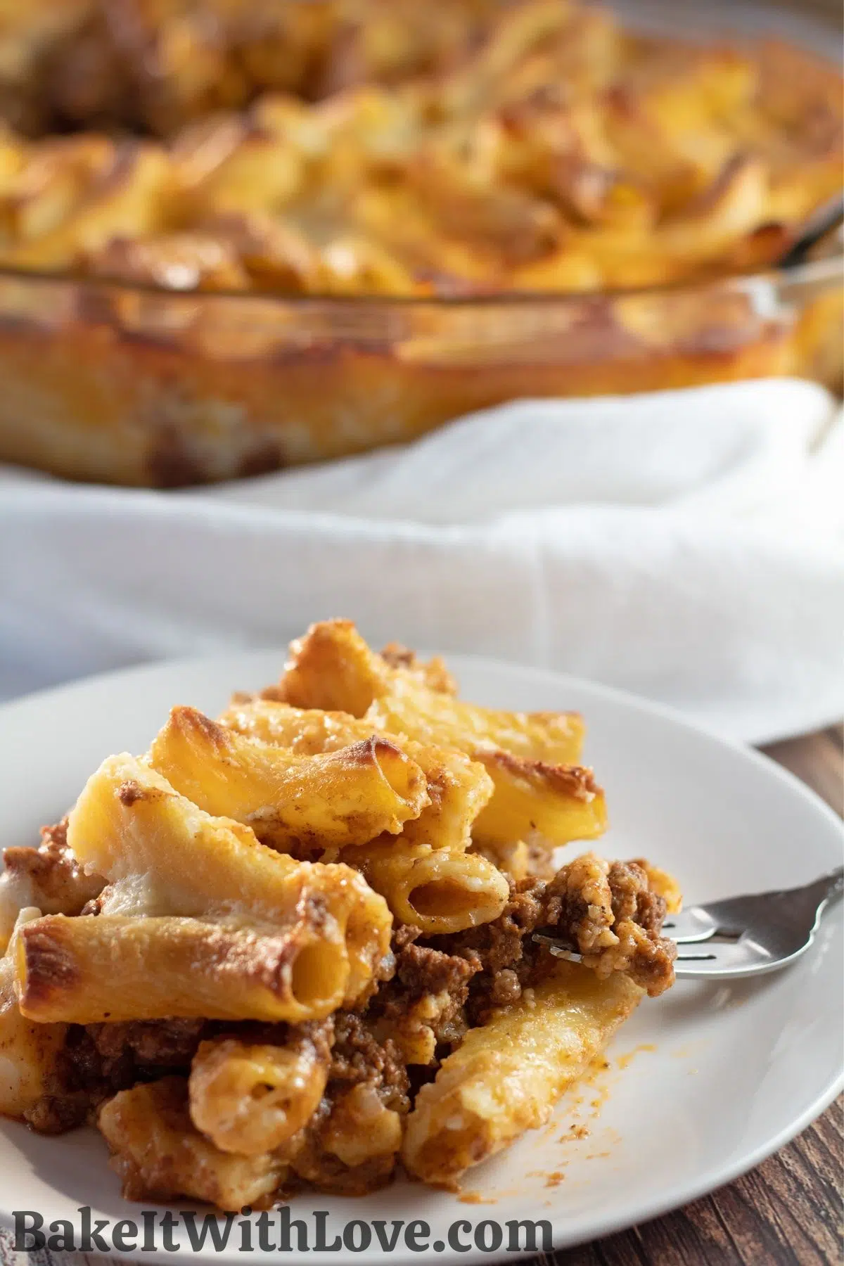 Layered bechamel pasta bake or macarona bechamel served on white dish.