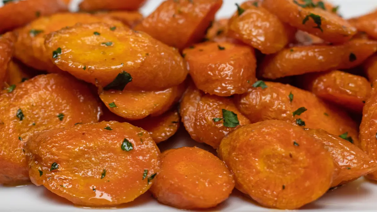 Easy air fryer carrots cooked to tender perfection and served on a white plate.