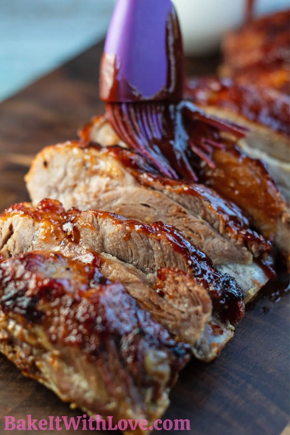 Sliced air fryer pork ribs on dark wooden cutting board.