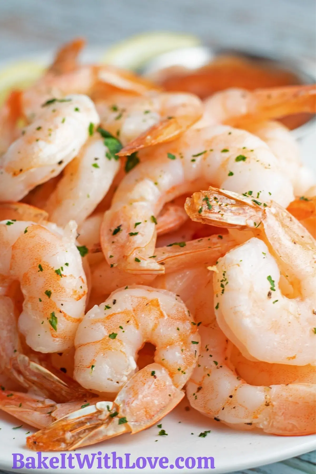 Air fryer shrimp served with lemon wedges and cocktail sauce.