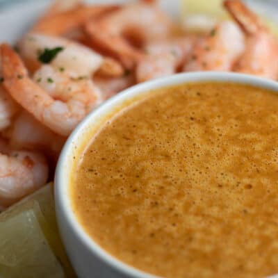 Bloves Sauce in a small bowl with shrimp in the background.