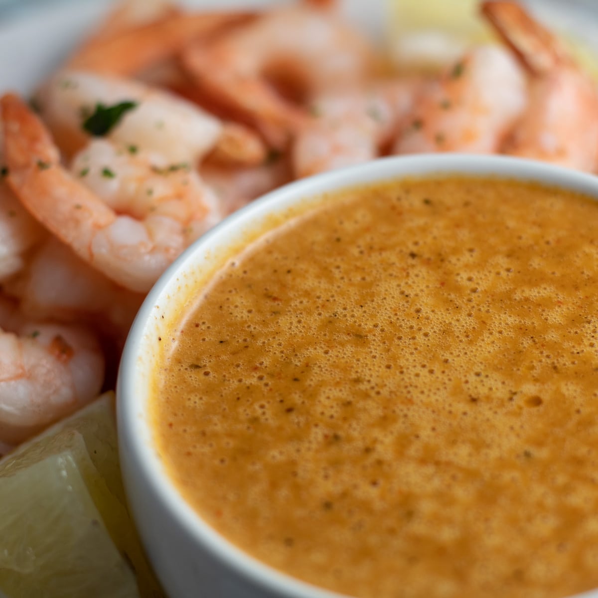 Blove's Sauce in a small bowl with shrimp in the background.
