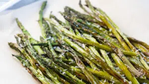 Air fryer asparagus roasted to perfection and served in tray.