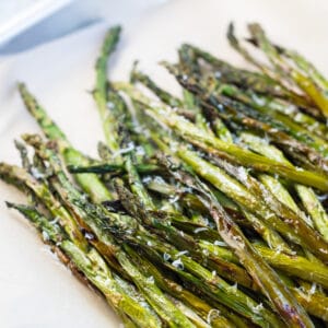 Air fryer asparagus roasted to perfection and served in tray.