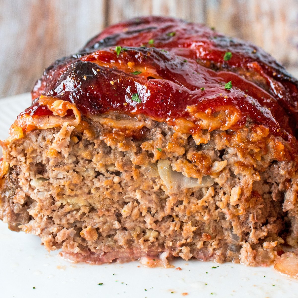 Square image of a bacon wrapped meatloaf.