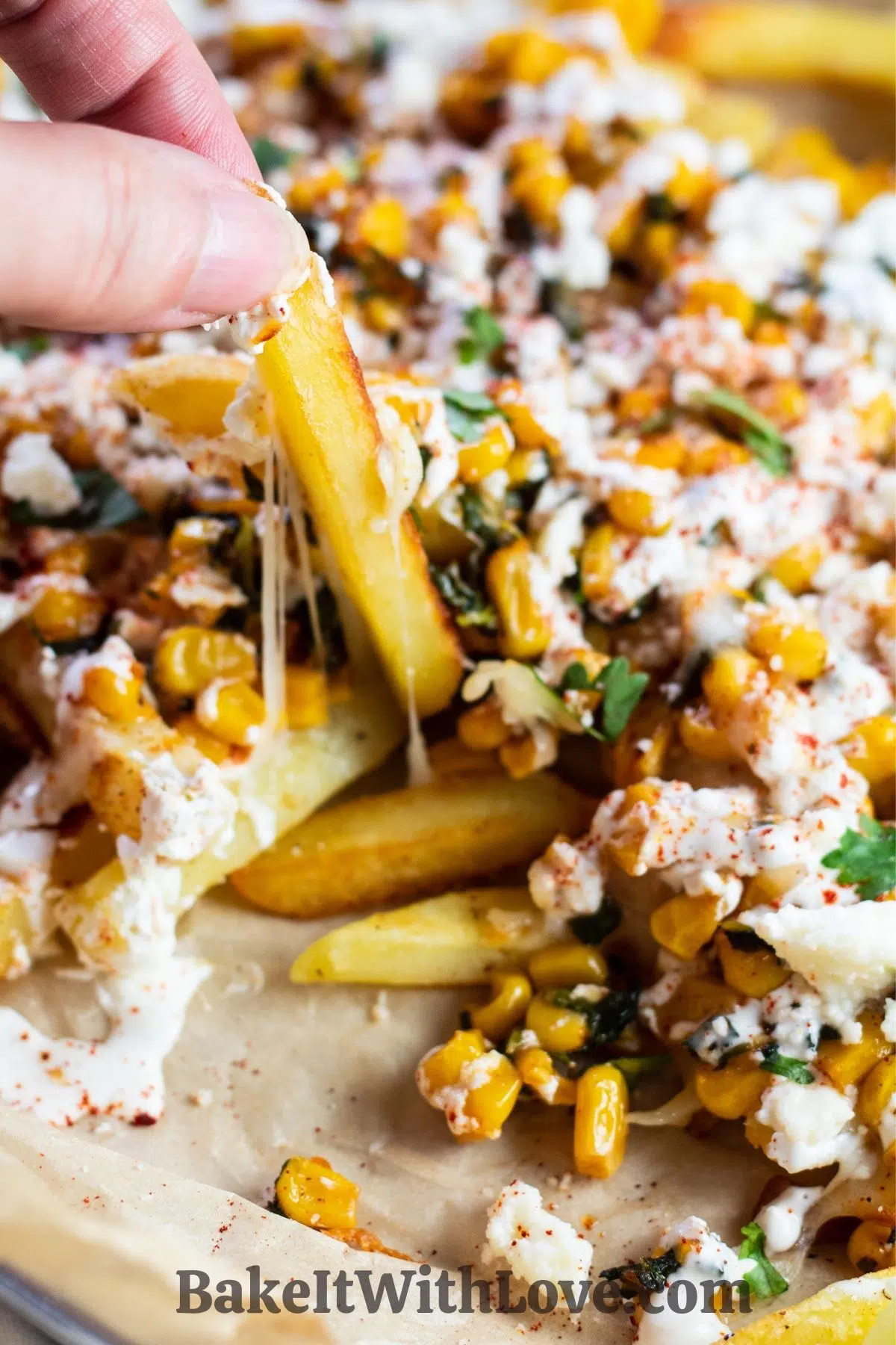Loaded elotes-style corn fries served in baking sheet on parchment paper.