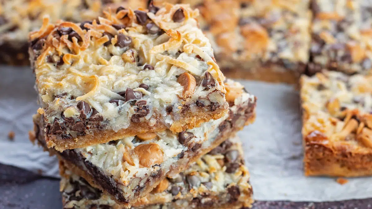 Stacked Hello Dolly Bars on parchment paper.